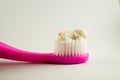 Herbal toothpaste on pink toothbrush isolated white background Royalty Free Stock Photo