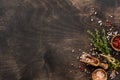 Herbs bunch thyme and condiments on old black wooden table. Thyme, sea salt and pepper. Royalty Free Stock Photo