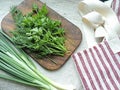 Herbs and chieves on old chopping board, handmade linen apron