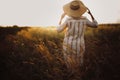 Herbs and grasses in sunset light on background of blurred woman in summer meadow. Wildflowers close up in warm light and rustic Royalty Free Stock Photo