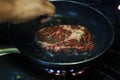 Herbs marinated beef rib eye steak cooking in hot grill Royalty Free Stock Photo