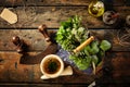 Herbs, oil and mezzaluna over old wooden table