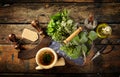 Herbs, scissors and mezzaluna over rustic table