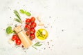 Herbs, spices and vegetables at white kitchen table. Royalty Free Stock Photo