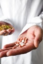 Herbs and synthetic medicine in doctor's hands