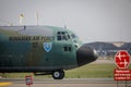 Hercules military cargo plane of the Romanian Air Force on Henri Coanda International Airport between commercial airplanes Royalty Free Stock Photo