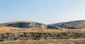 Herd of sheep grazing spread over the mountains and hills and a view of the sky. Royalty Free Stock Photo