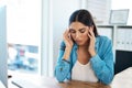 Here comes that stubborn tension headache again. a young businesswoman looking stressed out while working in an office. Royalty Free Stock Photo