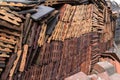 An interesting pattern or design is created by this large stack of house roof tiles.