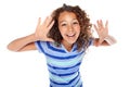 Here I am. Studio shot of a young girl gesturing against a white background. Royalty Free Stock Photo