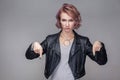 Here and right now. Portrait of bossy serious beautiful girl with short hair, makeup, casual style black leather jacket standing