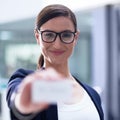 Here, take my card. Portrait of a happy businesswoman holding up a blank businesscard.