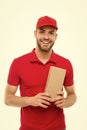 Here is your parcel. Ready to serve you. Man delivery service. Guy in red cap isolated on white background. Express Royalty Free Stock Photo