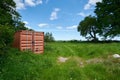 Herefordshire / UK - 6 June 2021: Mud coloured brown shipping container in Herefordshire field