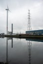 Herentals, Antwerp Province, Belgium - Reflections of a windmill electricity generator and high voltage wires and transmissions