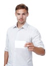 Heres my card. Studio portrait of a young man holding up a blank business card. Royalty Free Stock Photo