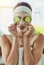 Heres my secret to nourished and hydrated the skin. an attractive young woman holding cucumber slices in front of her Royalty Free Stock Photo