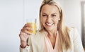 Heres to a good day ahead of us. Portrait of a cheerful middle aged businesswoman enjoying a glass of orange juice in Royalty Free Stock Photo