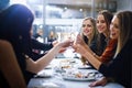 Heres to a good night with great friends. friends having a dinner party at a restaurant. Royalty Free Stock Photo