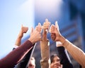 Heres to a great business. a group of people huddling together in a circle and showing thumbs up in the air. Royalty Free Stock Photo