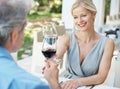 Heres to our love. Happy mature couple toasting their love with two glasses of wine while outdoors. Royalty Free Stock Photo