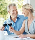 Heres to us. Happy mature couple toasting their love with two glasses of wine while outdoors. Royalty Free Stock Photo