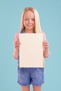 Heres what I think...A cute little girl holding up colorful copyspace while isolated.