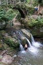 Tourist visit and swim at the idyllic small Schiessentuempel waterfall