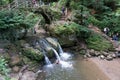 Tourist visit and swim at the idyllic small Schiessentuempel waterfall