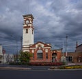 A heritage post office with storm clouds in the background