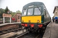 Heritage restored diesel train at railway station platform with Grosmont destination displayed. North Yorkshire Moors Railway