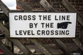 Heritage restored railway station sign advising passengers to cross the railway line via the level crossing at Levisham station s