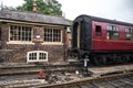 Heritage restored train carriage at railway station platform with Grosmont destination displayed. North Yorkshire Moors Railway