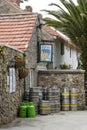 Gas bottles, beer, barrels and casts stacked outside a pub on Herm island, Guernsey, UK Royalty Free Stock Photo