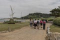 Herm Island Channel Islands a group of guided visitors passing the harbour on a walk around the island. Royalty Free Stock Photo