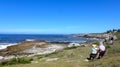 Hermanus, South Africa. An elderly couple sits on one of the many benches along the Cliff Path and enjoys the view Royalty Free Stock Photo
