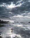 Hermanus, South Africa - Man in tidal pool reflecting the sky at dusk