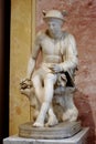 Seated Hermes with a tortoise. Marble statue. Roman work of the 2nd century AD after a Greek original of the 4th century BC Royalty Free Stock Photo