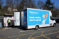 Hermes staff member and van at InPost online shopping pickup lockers