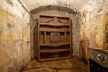 Hermetic rusty door of the bunker in underground abandoned tunnel. Mysterious old iron gate. Secret entrance Royalty Free Stock Photo