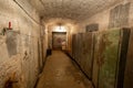 Hermetic rusty door of the bunker in underground abandoned tunnel. Mysterious old iron gate. Secret entrance Royalty Free Stock Photo