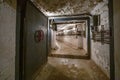 Hermetic rusty door of the bunker in underground abandoned tunnel. Mysterious old iron gate. Secret entrance Royalty Free Stock Photo