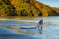 Hermosa beach, Costa Rica - December 14, 2021: Beautiful Playa Hermosa, Sentosa island and a man with a kayak, Costa