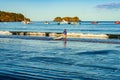 Hermosa beach, Costa Rica - December 14, 2021: Beautiful Playa Hermosa, Sentosa island and a man with a kayak, Costa