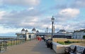 Herne bay promenade with people dressed as father Christmas walking along it and a sculpture of Amy Johnson . Royalty Free Stock Photo