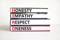 HERO honesty empathy respect oneness symbol. Concept words HERO honesty empathy respect oneness on books on beautiful white