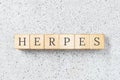 Herpes word written on building blocks on grey