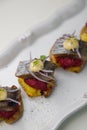 Herring canapes with pickled onions and baked potatoes. Appetizer on a platter close-up