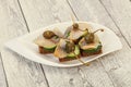 Herring fillet canape with caperberry Royalty Free Stock Photo