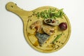 Herring fillet with herbs and spices on a wooden board. Top view Royalty Free Stock Photo